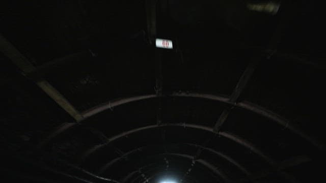 Cable runs inside a lighted mine tunnel