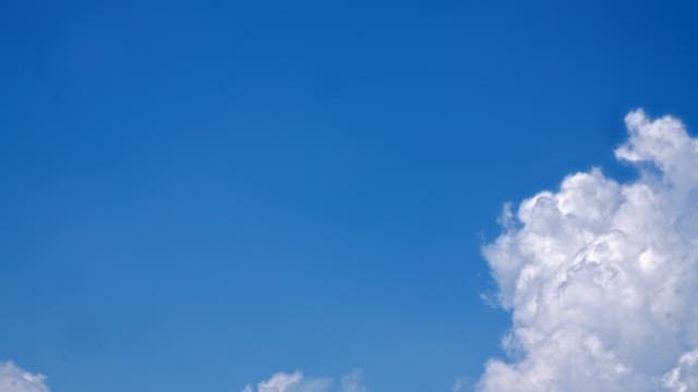 Clear blue sky with white fluffy cloudsin the afternoon