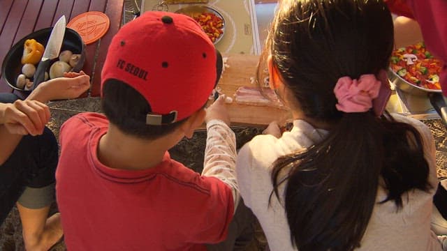 Children Preparing Food with Help from Their Parents