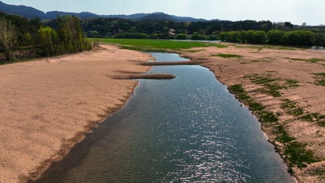 Serene river flowing through a sandy field