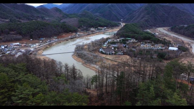 Village surrounded by rivers and lush green mountains