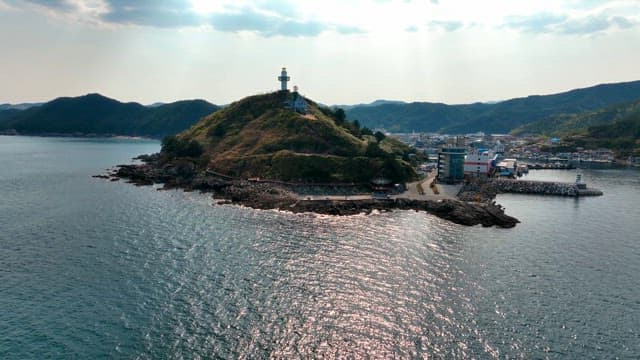 Coastal town with a lighthouse on a hill