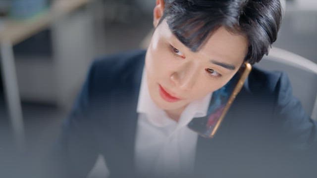 Man in a suit talking on the phone