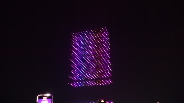 Colorful drone light show in nighttime sky