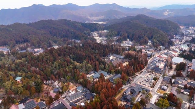 Scenic view of a town surrounded by mountains