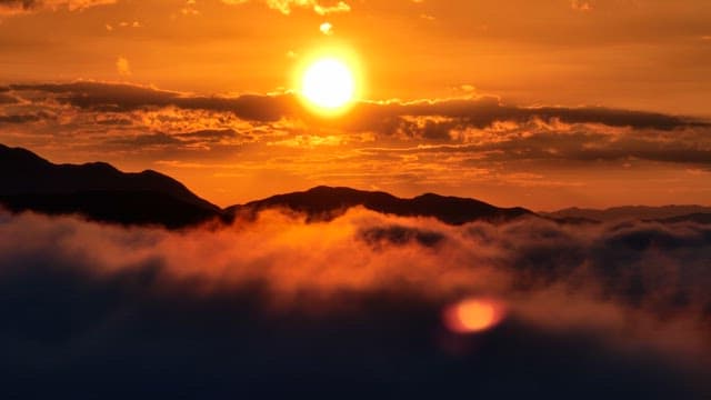 Sunset over mountains with clouds