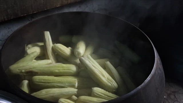 Boiling Corn in a Large Cauldron