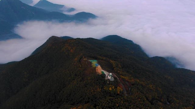 Lush Mountains Surrounded by Thick Fog