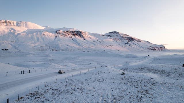 Snowy mountain landscape with a car