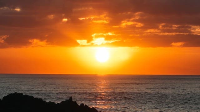 Sunset over the ocean with clouds