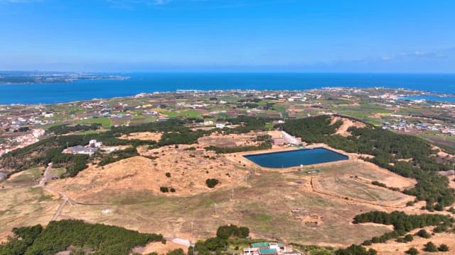 Vast landscape with fields and ocean