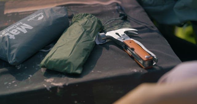 Person Standing Up with Camping Tools on the Table