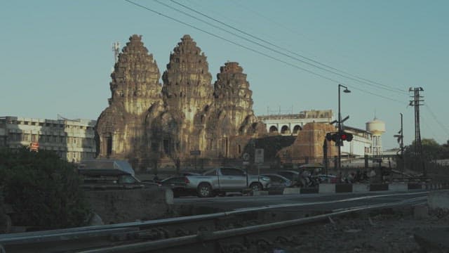 Ancient Temple Near the Crossing with Train Passing by