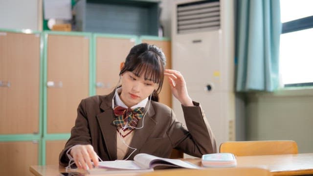 Students studying and sharing earphones