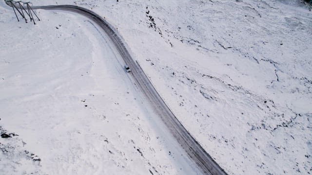 Car driving on a snowy mountain road