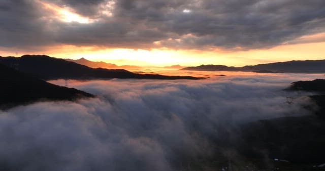 Sunrise over mountains with clouds