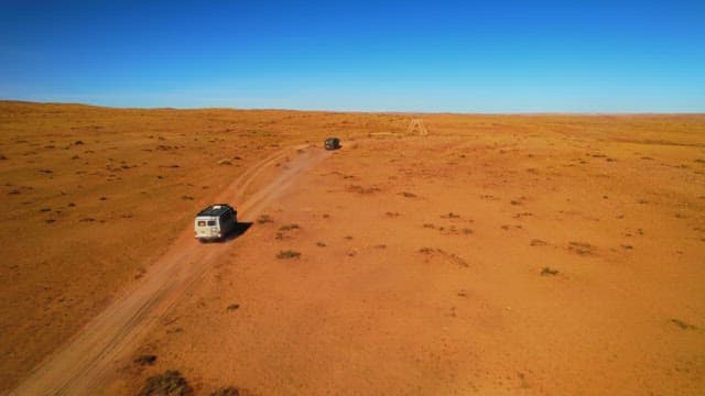 Vehicle Crossing the Vast Desert