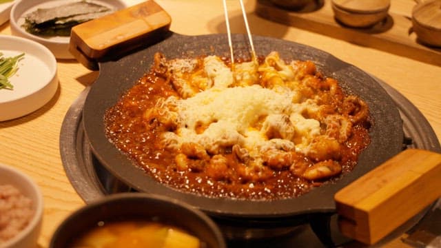 Melted Cheese on Top of the Stir-Fried Octopus