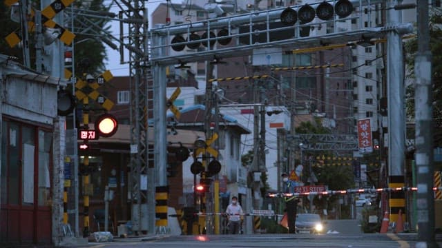 Guard Directing Traffic at a Railroad Crossing