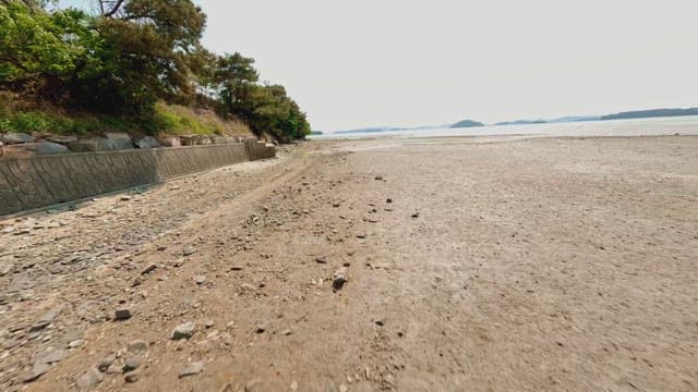 Vast sandy beach with distant hills