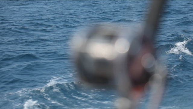 Fishing reel against the ocean backdrop