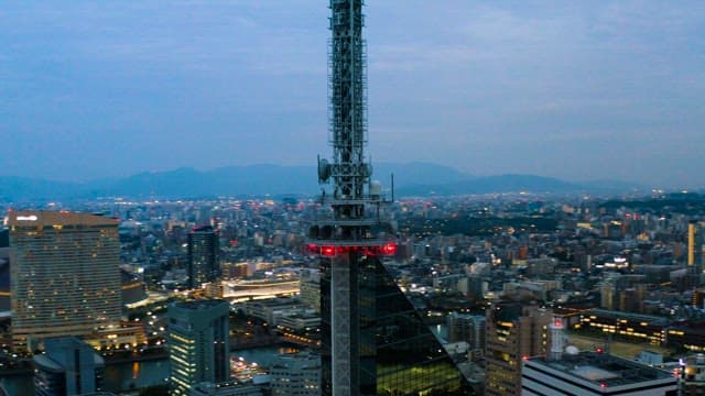 Tower Towering over a City at Dusk