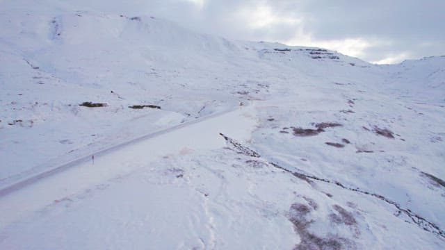 Car driving through a snowy landscape