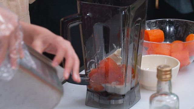 Preparing Carrot Juice with Blender in the Kitchen