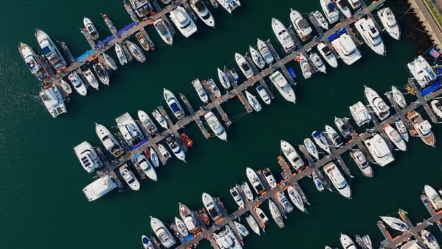 Numerous yachts anchored in the harbor on a clear day