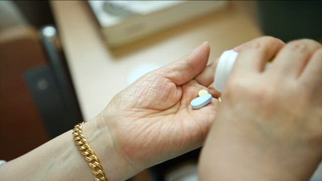 Elderly Person Handling Medication