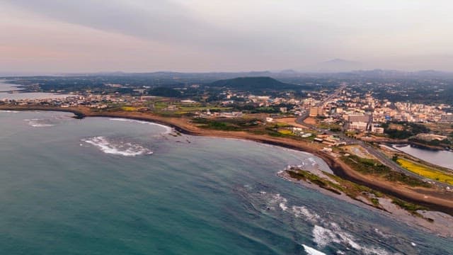 Coastal city with mountains in the distance