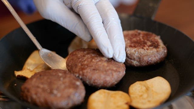 Cooking Tteokgalbi Patties Using a Spoon on a Frying Pan