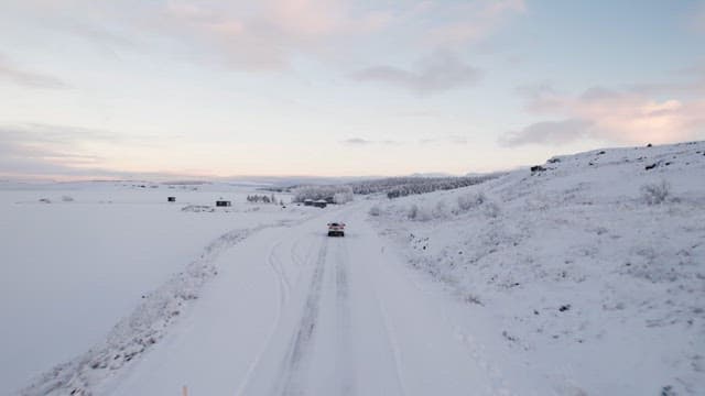Car driving through a snowy landscape