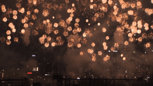 Colorful Fireworks Display Over the City Skyline and River