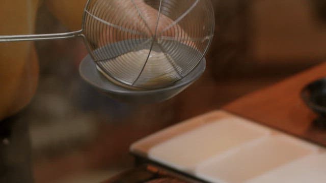 Preparing freshly made dumplings in bowls in a cozy kitchen setting