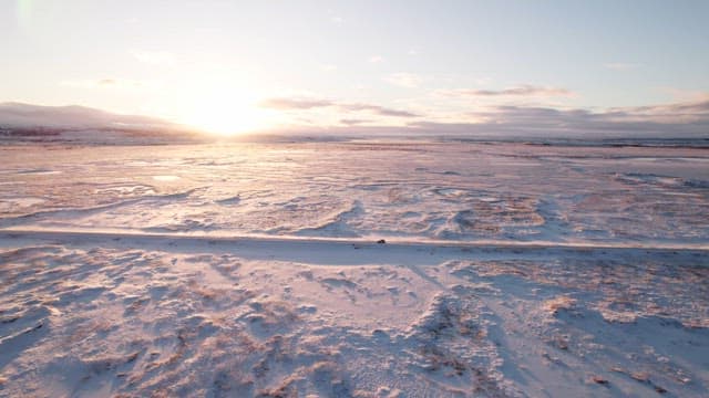 Snowy landscape with a car on a road
