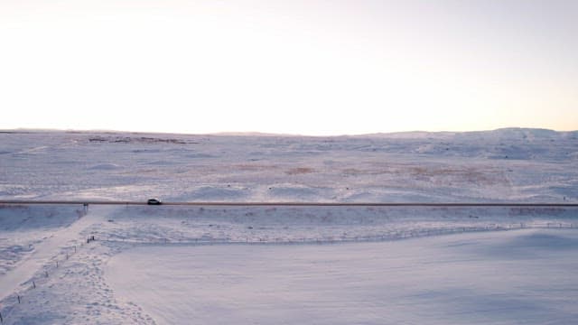 Car driving through a snowy landscape