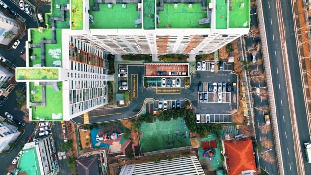 View of Green Rooftops of Buildings and Busy Roads