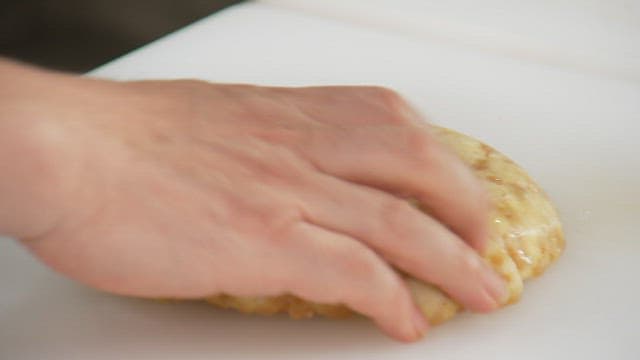 Slicing a freshly baked pancake on a cutting board