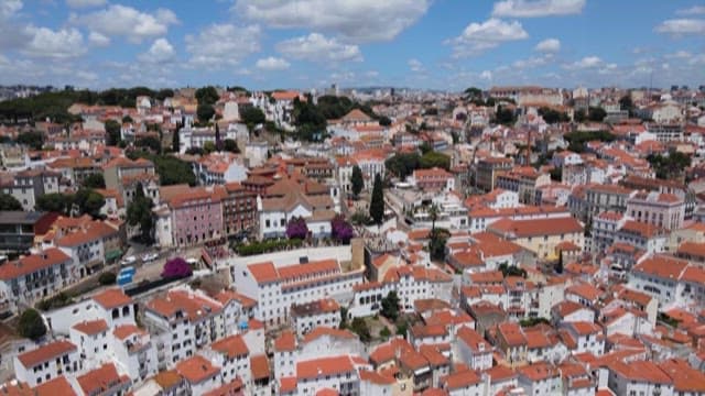 Quaint Town with Red Rooftops Under a Blue Sky
