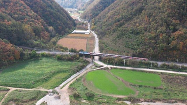 Train passing through a scenic autumn mountains