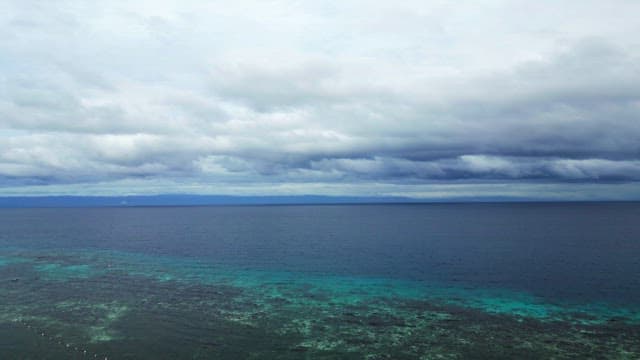 Vast ocean under a cloudy sky