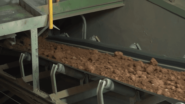 Conveyor belt transporting soil