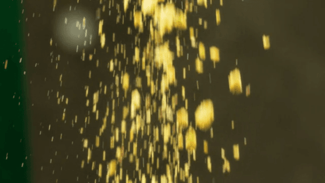 Crushed nuts falling in a dark space