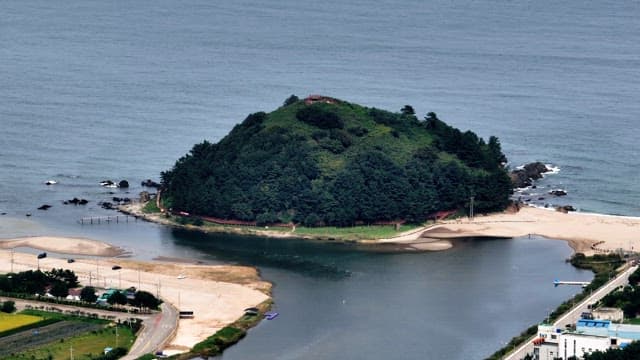 Small lush island surrounded by the sea