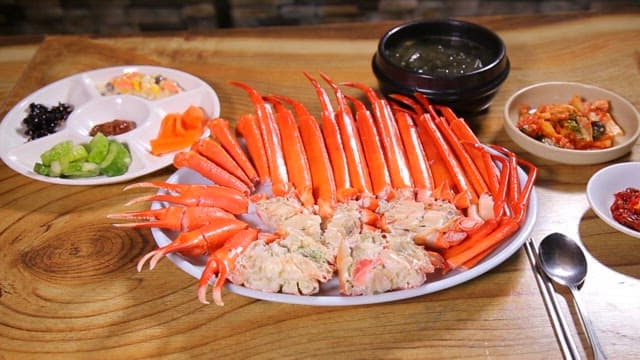 Plate of red crab legs with side dishes