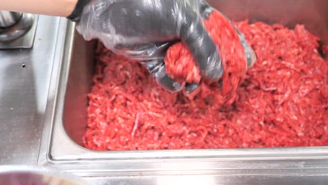 Preparing a Beef Tartare with Fresh Vegetables and Minced Meat in a Commercial Kitchen
