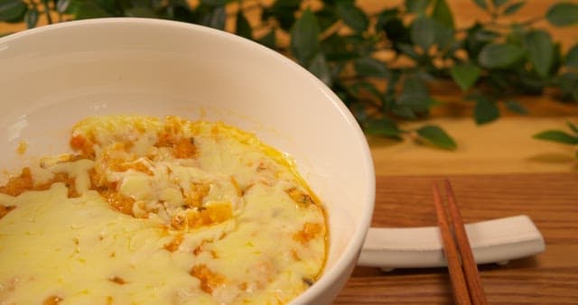 Cheese Gratin Scooped Out with a Wooden Spoon