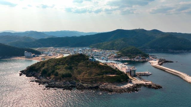 Coastal town with a lighthouse on a hill