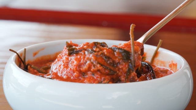 Spoonful of sweet and sour soybean paste in a bowl